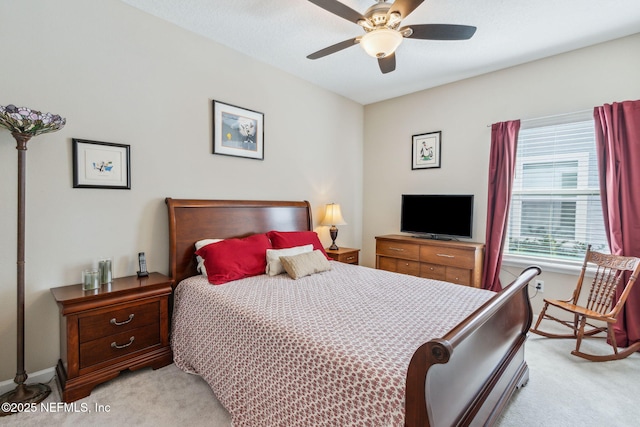 bedroom with ceiling fan and light carpet