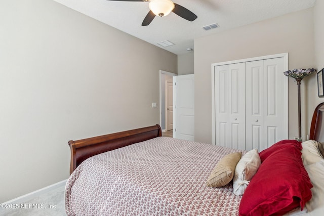 carpeted bedroom featuring ceiling fan and a closet