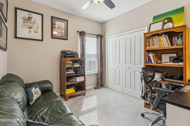 carpeted office space with ceiling fan