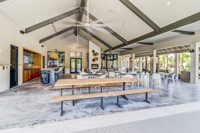 dining area featuring high vaulted ceiling, beam ceiling, and french doors