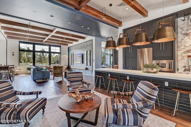 living room with beam ceiling and dark hardwood / wood-style flooring