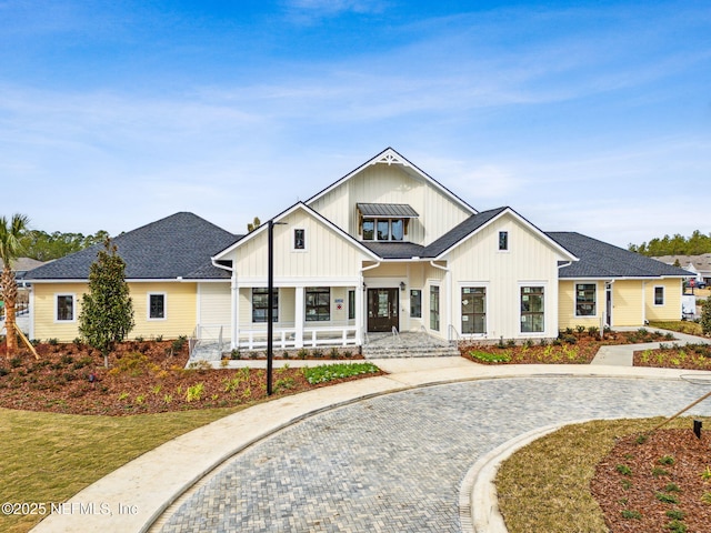 modern inspired farmhouse featuring a porch and a front lawn