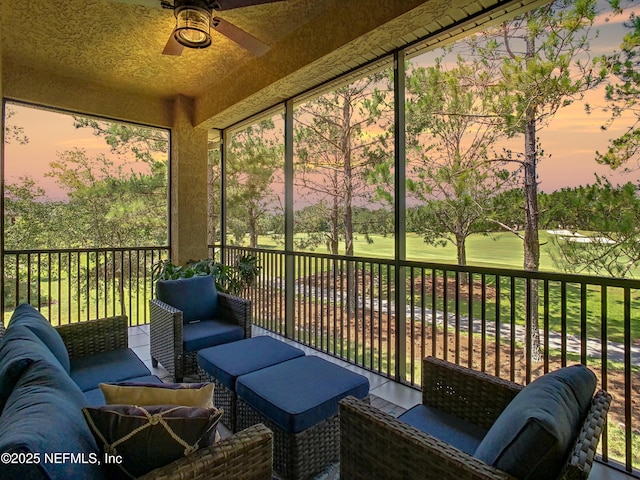 sunroom with ceiling fan and a wealth of natural light