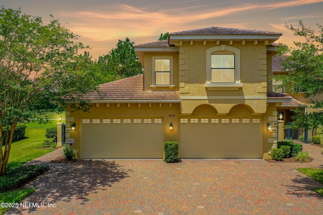 mediterranean / spanish house with a garage