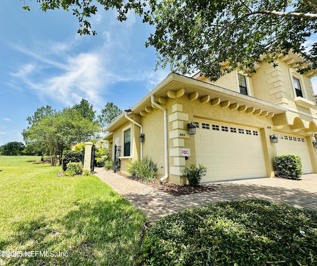 view of side of home featuring a yard and a garage