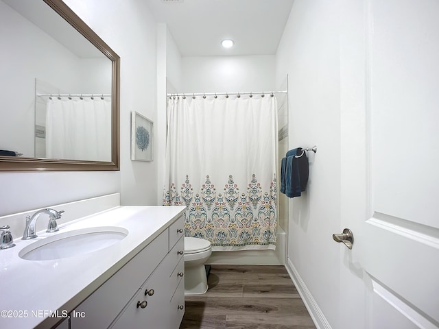 full bathroom with vanity, toilet, shower / tub combo, and wood-type flooring