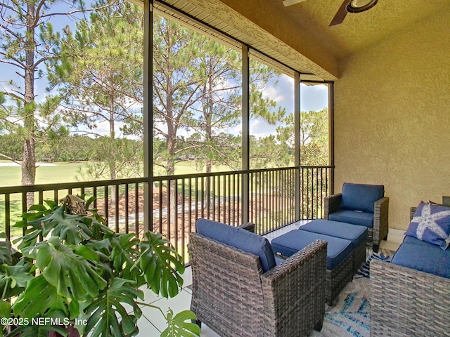 unfurnished sunroom with ceiling fan