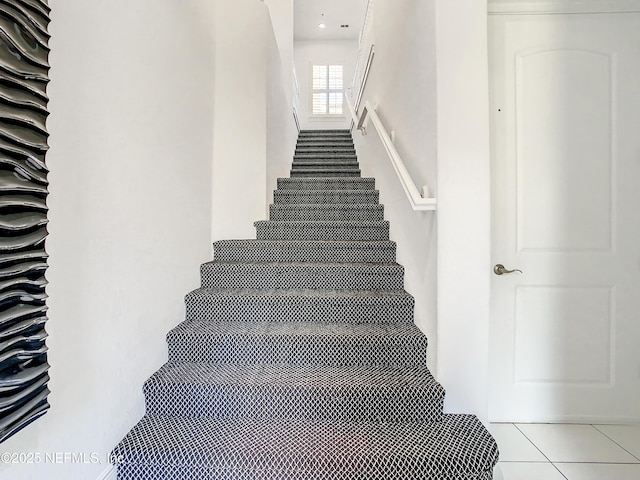 stairs featuring tile patterned flooring