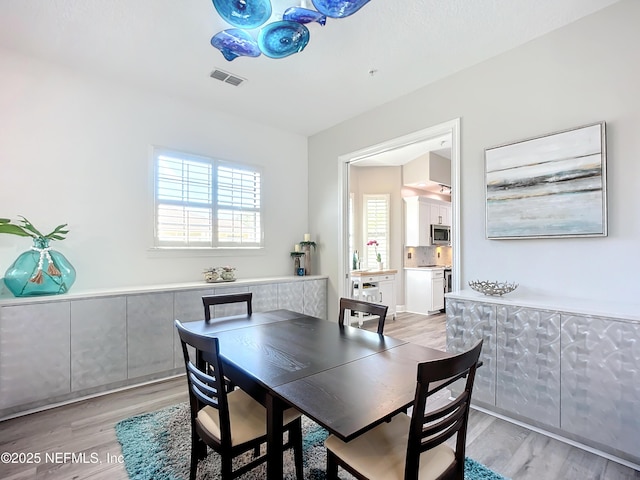 dining space featuring light wood-type flooring