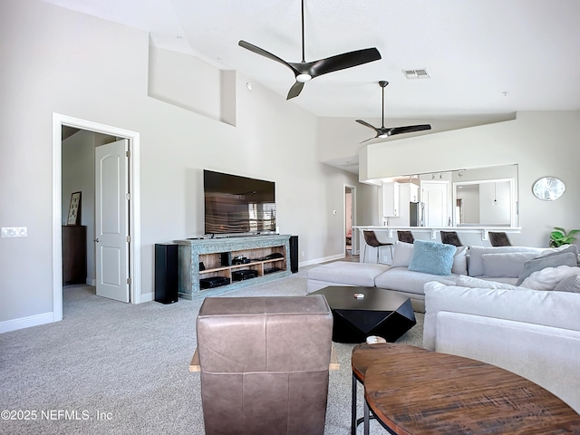 living room featuring light carpet, high vaulted ceiling, and ceiling fan