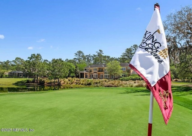 surrounding community with a lawn and a water view