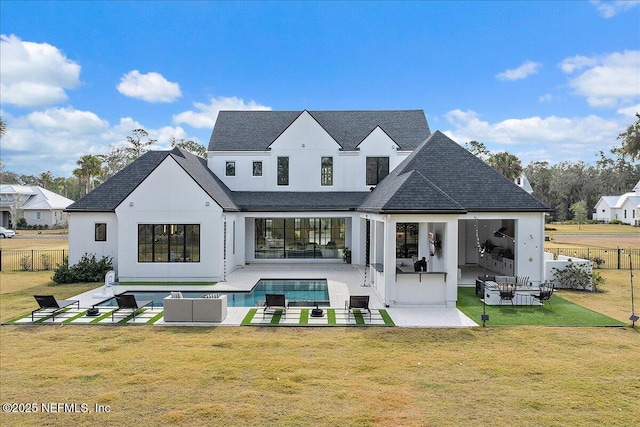 back of house featuring an outdoor hangout area, fence, a lawn, a fenced in pool, and a patio area