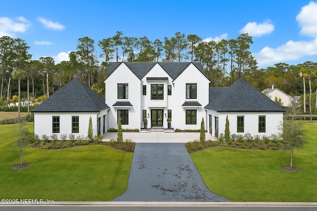 179 Coastal Grove Ct, Ponte Vedra Beach, FL 32082 - view of front facade with stucco siding, a front yard, driveway, and roof with shingles