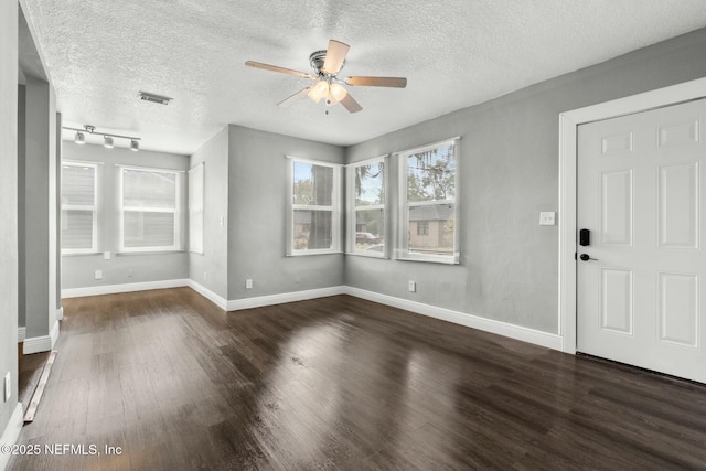 interior space with ceiling fan, dark hardwood / wood-style floors, and a textured ceiling