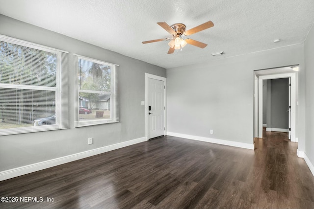 unfurnished room featuring ceiling fan, dark hardwood / wood-style flooring, and a textured ceiling