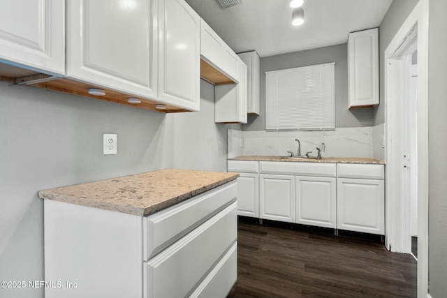 kitchen featuring white cabinetry, dark hardwood / wood-style flooring, and sink