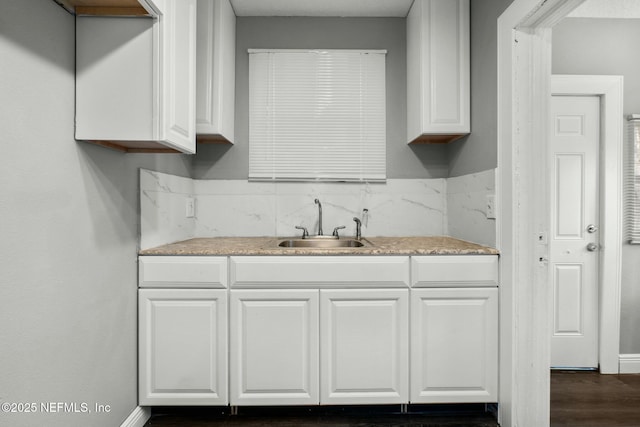 kitchen featuring white cabinetry and sink