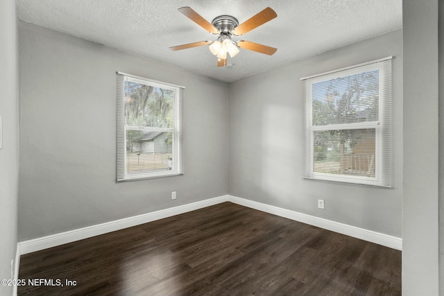 spare room with dark hardwood / wood-style flooring, a textured ceiling, and ceiling fan