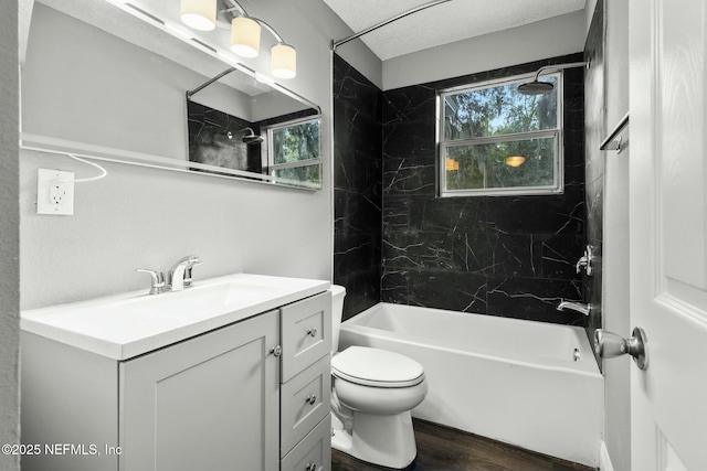 full bathroom with vanity, tiled shower / bath combo, plenty of natural light, and toilet