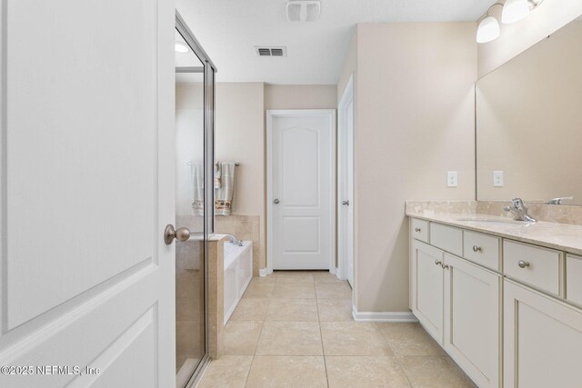 bathroom featuring tile patterned floors, vanity, and independent shower and bath