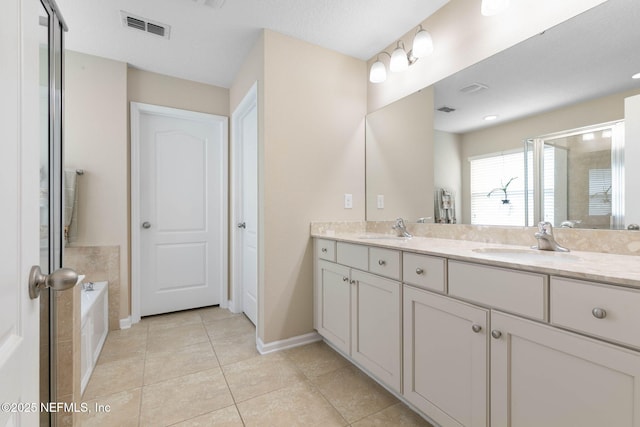 bathroom with tile patterned flooring, vanity, and plus walk in shower