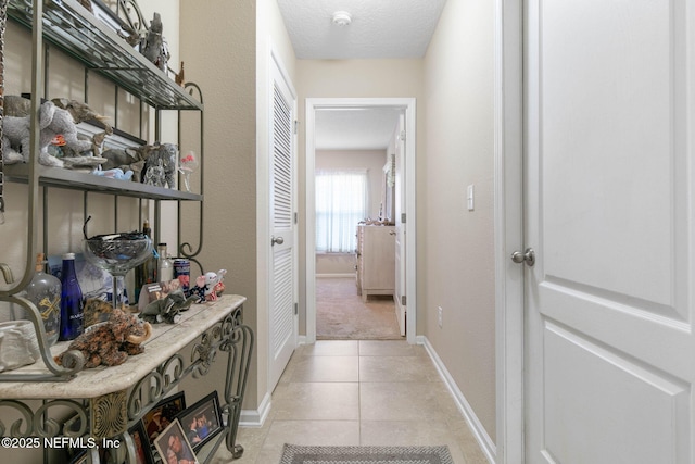 corridor with light tile patterned floors