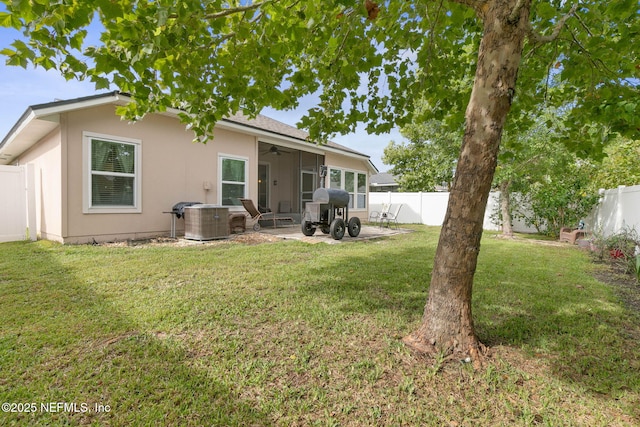 back of house with a lawn, ceiling fan, and a patio