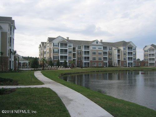 exterior space featuring a lawn and a water view