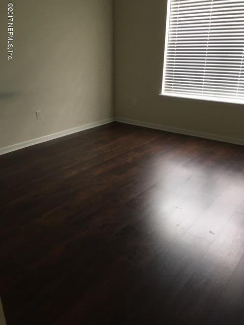 spare room featuring dark hardwood / wood-style flooring