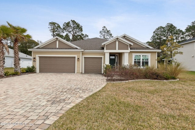 view of front of house with a front lawn and a garage