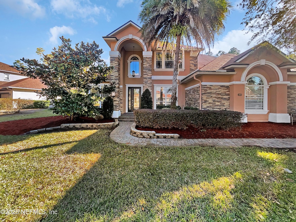 mediterranean / spanish-style home featuring a front yard