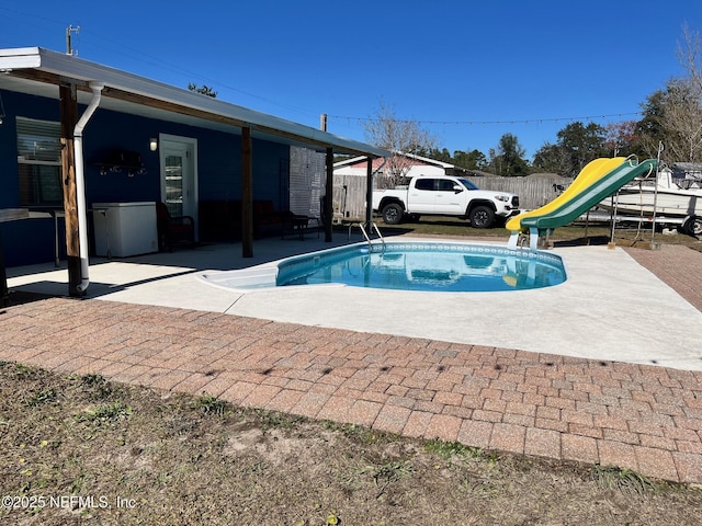 view of pool featuring a patio area and a water slide