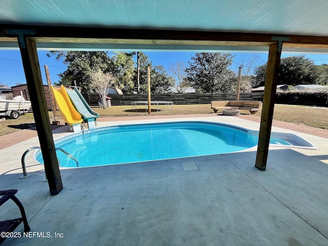 view of pool with a playground, a patio area, and a water slide