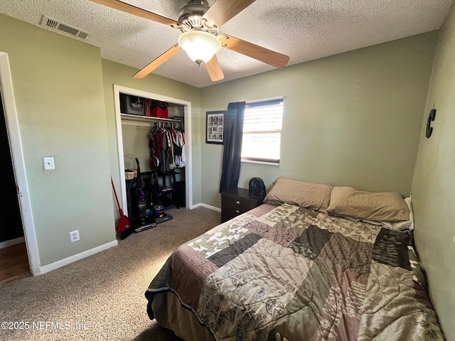 bedroom featuring carpet flooring, ceiling fan, a closet, and a textured ceiling