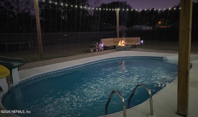 view of pool with a fire pit