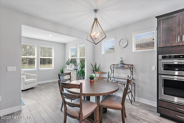 dining room featuring a notable chandelier and light hardwood / wood-style flooring