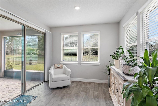 sitting room featuring a textured ceiling and light hardwood / wood-style flooring