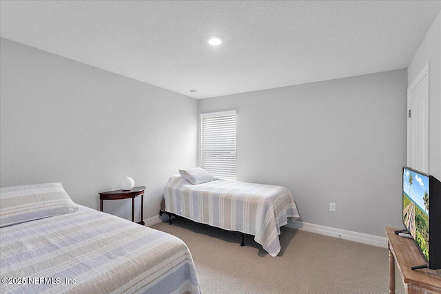 bedroom with a textured ceiling and carpet flooring