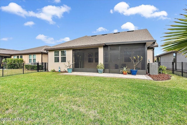 rear view of house featuring a sunroom, cooling unit, and a lawn