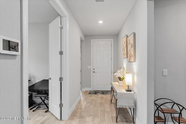 hallway with light hardwood / wood-style flooring