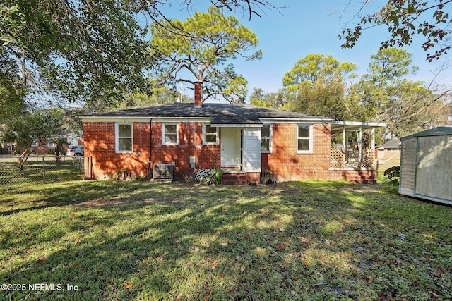 ranch-style home with a front lawn and central AC unit