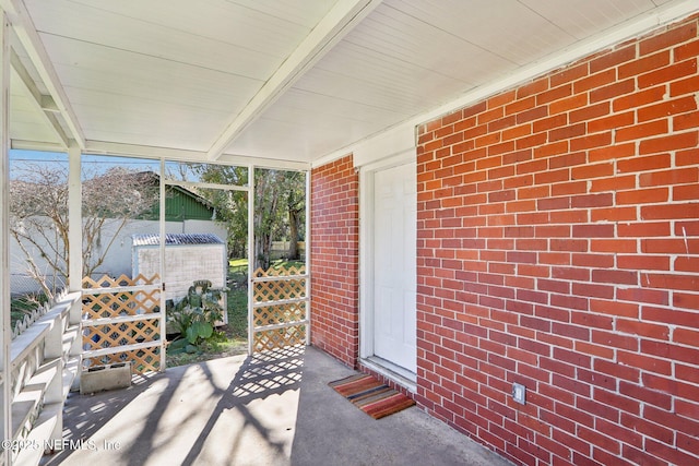 unfurnished sunroom with beam ceiling