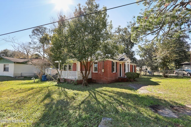 view of side of home featuring a lawn