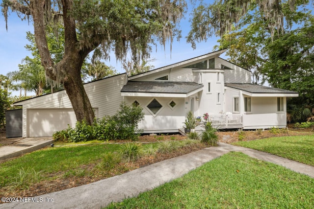 view of front of house with a garage and a front lawn