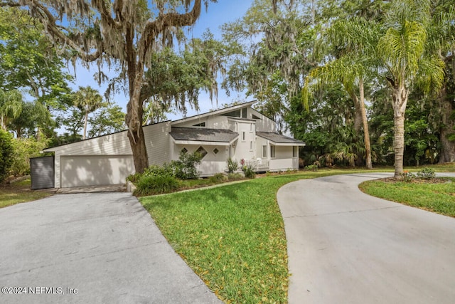 view of front of house with a garage and a front lawn