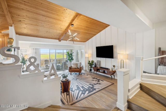 living room featuring light hardwood / wood-style floors, lofted ceiling with beams, wood ceiling, and an inviting chandelier