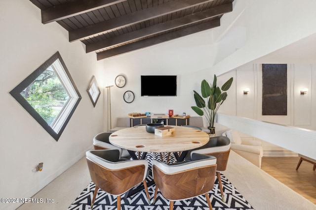 dining space with beam ceiling, high vaulted ceiling, and wood ceiling