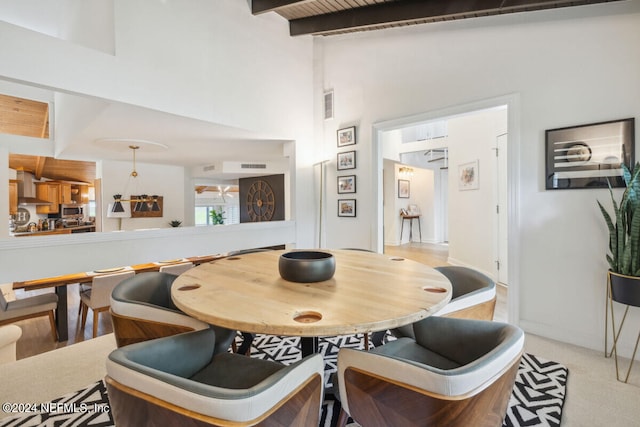 dining area with lofted ceiling with beams and wood ceiling