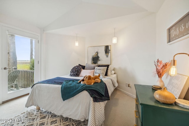 bedroom featuring carpet, lofted ceiling, and access to outside