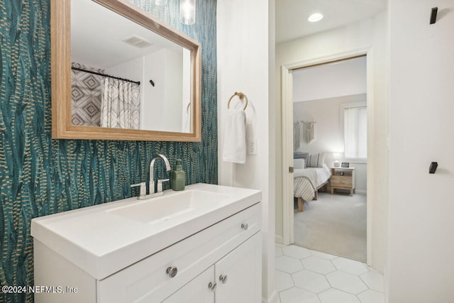 bathroom featuring tile patterned flooring and vanity